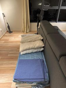 a living room with a couch with pillows on it at Arte Cheras in Kuala Lumpur
