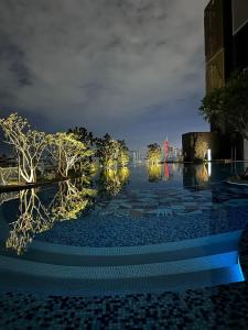 a pool at night with trees and lights at Arte Cheras in Kuala Lumpur