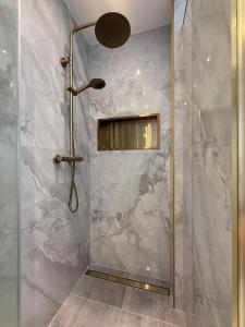 a bathroom with a shower with a glass door at City Apartment Varel in Varel +31 photos