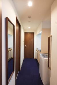 a small room with a door and a washing machine at Kyoto Gojo T 京都五条ツイン in Kyoto