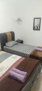 Postel nebo postele na pokoji v ubytování AHNa HOMESTAY TELUK KEMANG