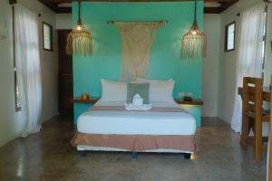 a bedroom with a large white bed in a room at G Villas Siargao in General Luna
