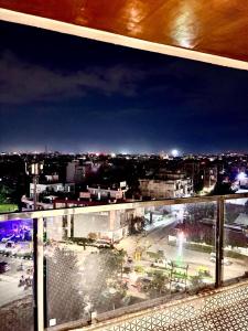 a view of a city at night from a window at 3 BHK fully furnished flat in Jaipur +10 photos