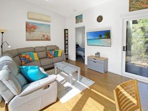 a living room with a couch and a table at Phillip Island Villa - R a m a d a Resort in Cowes