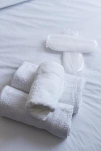 a pile of towels sitting on top of a bed at Casa Natura in Kilkis +75 photos