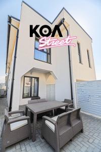 a restaurant with a table and chairs in front of a building at KOA - Street in Braşov