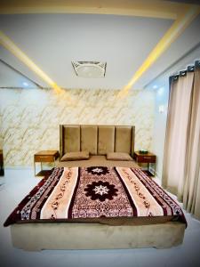 a bedroom with a large bed in a room at Eiffel Luxora Lilac one bed in Lahore