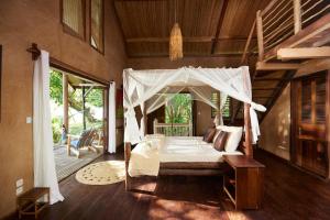 a bedroom with a bed with a canopy at Villa zakitoo in Sainte Marie
