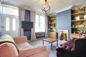 a living room with a couch and a chair at Prince Albert's Place in Hebden Bridge