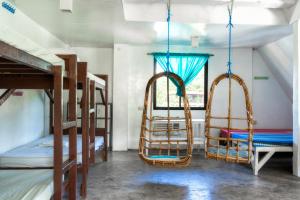 a room with two bunk beds and a window at Aroha Hostel in Coron