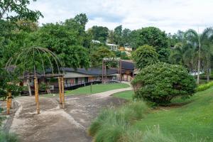 a building with a playground in front of a park at Binlha Raft Resort in Sai Yok
