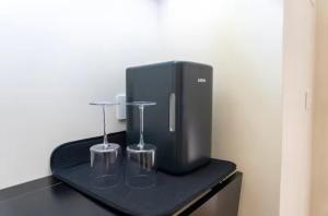 a black appliance on a black table with two glasses at A casa di Clà in Gaeta