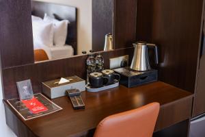 a desk in a hotel room with a coffee maker at Elissa Hotel & Suites in Kangar