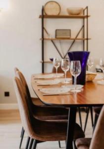 a dining room table with wine glasses on it at CASTEL SAINT CLAIR PRESTIGE - 2 Chambres - HYPER CENTRE in Deauville