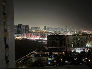 a view of a city skyline at night at Orient Tower 1814 in Ajman 