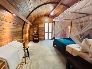 a bedroom with a canopy bed and a desk at Garden Oasis Rekawa in Rekawa