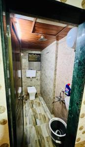 a small bathroom with a toilet and a sink at Hotel comfort in Mumbai