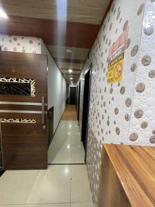 a hallway with a wall with a sign on it at Hotel comfort in Mumbai