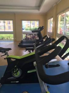 a gym with several treadmills in a room at Homey 2BR Condo in San Remo Oasis, Cebu City in Cebu City
