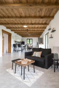 a living room with a black couch and a table at Chalupa Seč in Seč