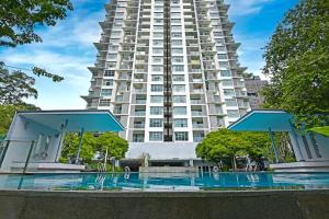 a large apartment building with a pool in front of it at The Pureloft Suites - Bukit Bintang KLCC in Kuala Lumpur