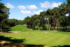 a golf course with people playing on a green at MAGNIFIQUE Mobil home - camping 4 étoiles -Les Charmettes 409 - Charente Maritime in Les Mathes