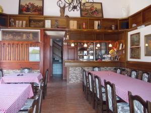 a dining room with pink tables and chairs at Kuća za odmor "Karalic" in Ležimir