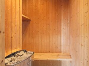 a wooden sauna with a tub in it at 8 person holiday home in Væggerløse in Marielyst