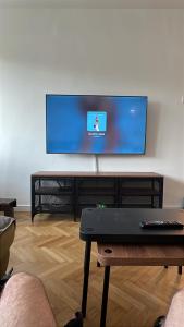 a living room with a flat screen tv on a wall at Alma Residence Amzei in Văleni