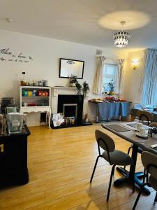 a living room with a table and chairs and a fireplace at Sonas house in Kilkenny +53 photos