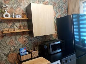 a microwave on top of a counter in a kitchen at Chillroom in Rąbień +9 photos