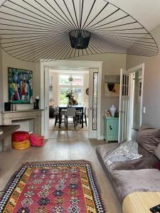 a living room with a couch and a table at Stylish * Sunny * Cosy House in Heemstede