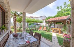 a patio with a table and a gazebo at Damir in Dajla