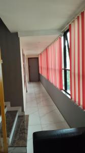 a hallway with red and white stripes on the walls at Tamar Residancy in Padinjarathara