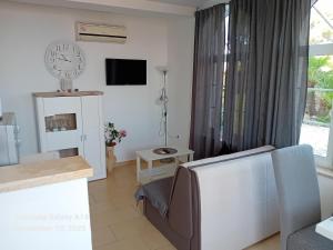a living room with a couch and a tv at Vivi studio apartments in Mali Lošinj
