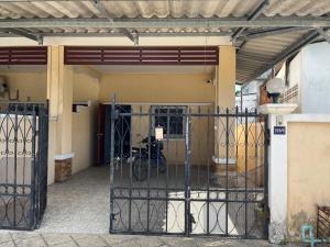 a gate to a building with a bike parked inside at Kbk home in Yala