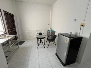 a room with a small table and a small refrigerator at Kbk home in Yala