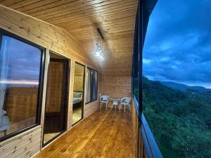 a balcony with two chairs and a view of the mountains at chemi kera chalet 2 in Angisa