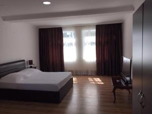 Ένα ή περισσότερα κρεβάτια σε δωμάτιο στο Hotel Simpatia