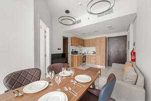 a dining room with a table and a couch at FIRST CLASS 1BR Waterfront Bliss in Abu Dhabi