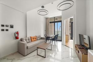 a living room with a couch and a table at FIRST CLASS 1BR Waterfront Bliss in Abu Dhabi