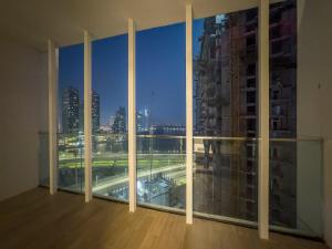 a large window with a view of a city at FIRST CLASS 1BR Waterfront Bliss in Abu Dhabi