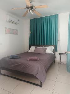 a bedroom with a bed with a green curtain at Efterpis12 St. House in Paralimni +18 photos