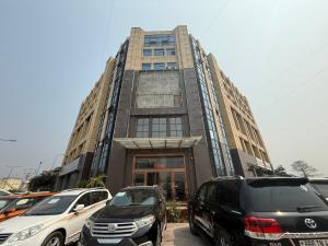 a tall building with cars parked in front of it at Easy home in Brazzaville