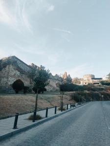 an empty road with trees on the side of a hill at Lux Rooms Pasha's Gardens Ιpirou 4 Agios Pavlos in Thessaloniki