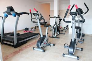 a gym with three exercise bikes and a treadmill at Apartments Villa Milna 1 in Budva