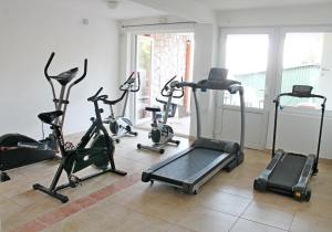 a gym with several exercise bikes in a room at Apartments Villa Milna 1 in Budva