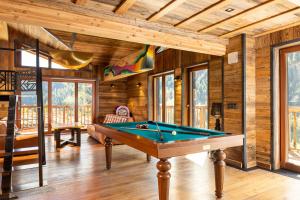 a pool table in a room with wooden walls at Black Diamond - Tignes in Les Brévières