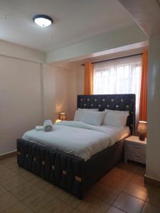 Postel nebo postele na pokoji v ubytování Dala kisumu two bedrooms