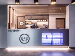 a reception area of a kitchen in a building at B&B Hotel Augsburg-Nord in Augsburg